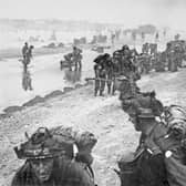 Allied troops from the 8th Brigade, 3rd Infantry Division of the British Second Army come ashore on Queen Red beach, Sword Beach area from Landing Craft Infantry (LCI) on the morning of D-Day during Operation Overlord.  Pic: Getty Images