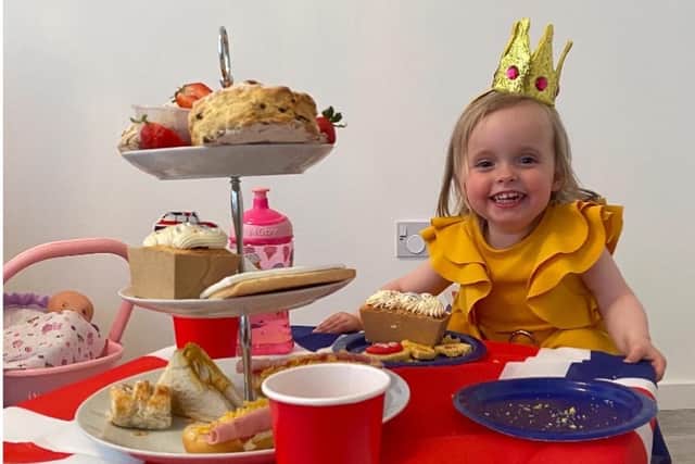 One-year-old Harley Rose from Falkirk has a fine time enjoying her Platinum Jubilee afternoon tea