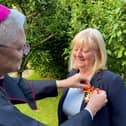 Archbishop Leo Cushley presented Angela with her award.