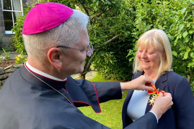 Archbishop Leo Cushley presented Angela with her award.