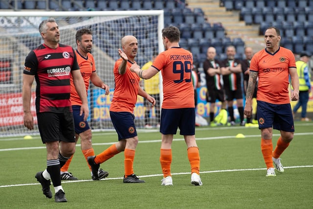 Tournament winners Uniao Desportiva celebrating scoring a goal