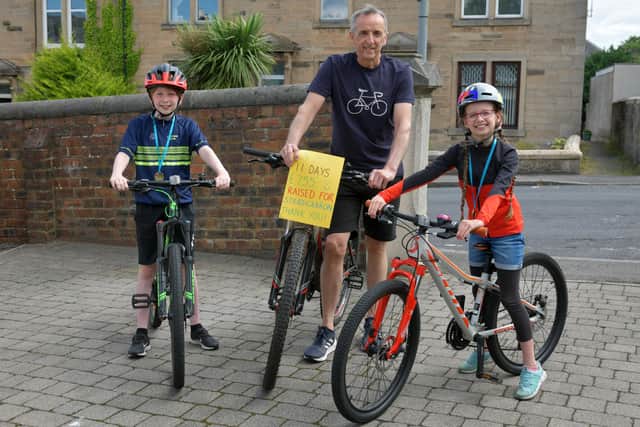 Lewis Baird and dad Colin cycled 85 miles in eight days for Strathcarron Hospice. Sister Stella Baird also cycled ten miles to add to the £755 total. Picture: Michael Gillen.
