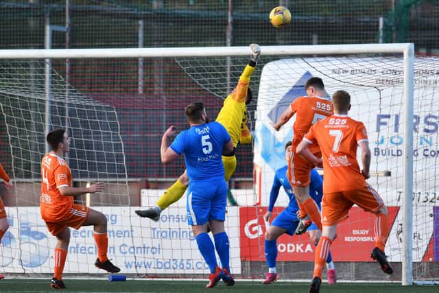 Bo'ness goalkeeper Fraser Currid keeps out a header from close range
