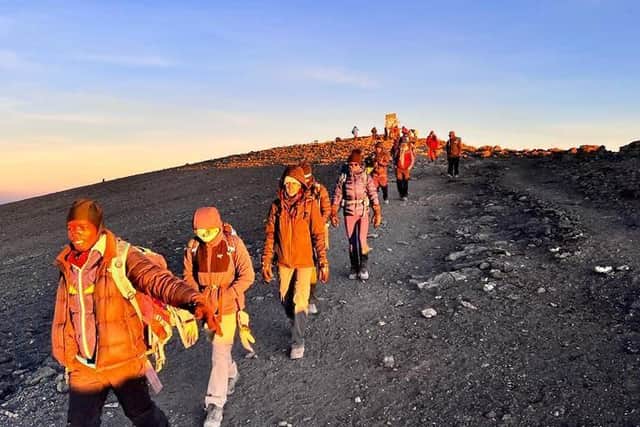 Walking in the early morning as they head for the top of Kilimanjaro