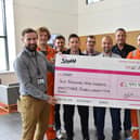 The Ineos C Shift cycle team hand over the money they raised to the Scottish Association for Mental Health (SAMH)