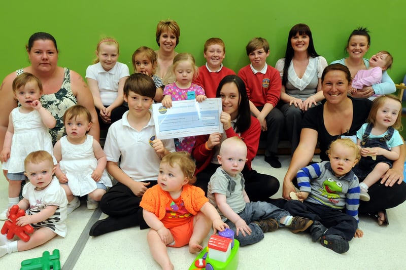 These parents and toddlers have every reason to look delighted after raising money in a smile challenge in 2013. Who can tell us more?
