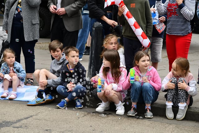 Youngsters await the arrival of the procession.