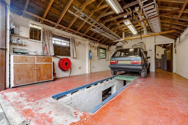 The generous detached garage with inspection pit, workshop and cellar.