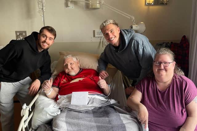 Falkirk FC players Brad Spencer and Tom Lang visit life-long Falkirk supporter William Lyndsay in Strathcarron Hospice. Pictured with William's wife Lorraine. Pic: Contributed