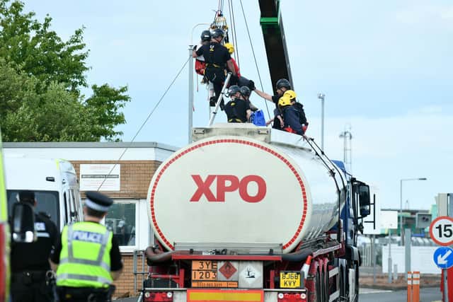 Police prepare to remove protesters from the tanker at Ineos terminal, bringing them down via a hoist and pulley system. Pic Michael Gillen