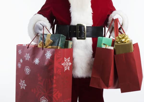 Santa Carrying Shopping Bags --- Image by © Royalty-Free/Corbis
