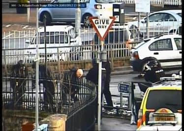 Snapshot of CCTV which shows two men being arrested for a terrifying raid.