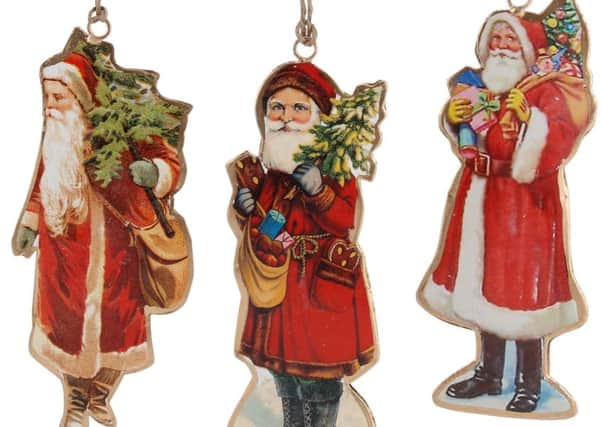 Father Christmas tin decorations, available from The Oak Room. Photo: PA Photo/Handout