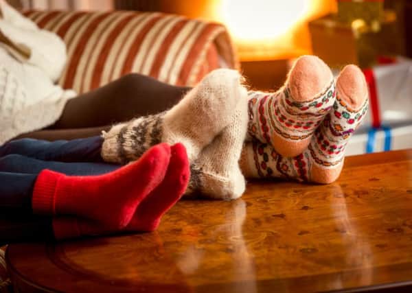 A family cosying up together in their warm house. Photo: PA Photo/thinkstockphotos.