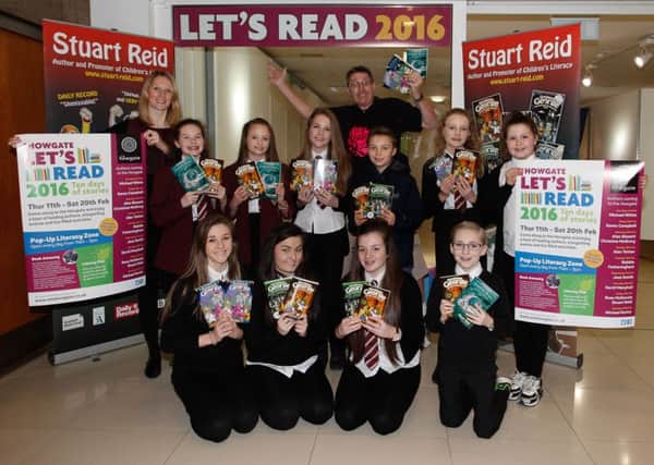 Preparing for the Lets Read event are pupils from Falkirk High School, Howgate marketing manager Margaret Foy and author Stuart Reid