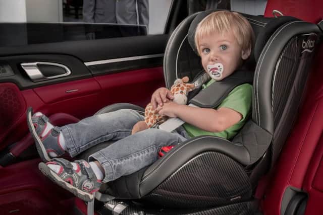 A child in the back of a car, as many parents don't know the details of child seat regulations.