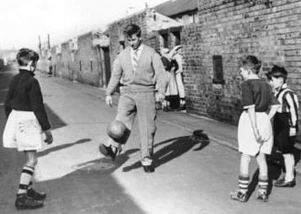 Who's this legend having a kickabout in the street?