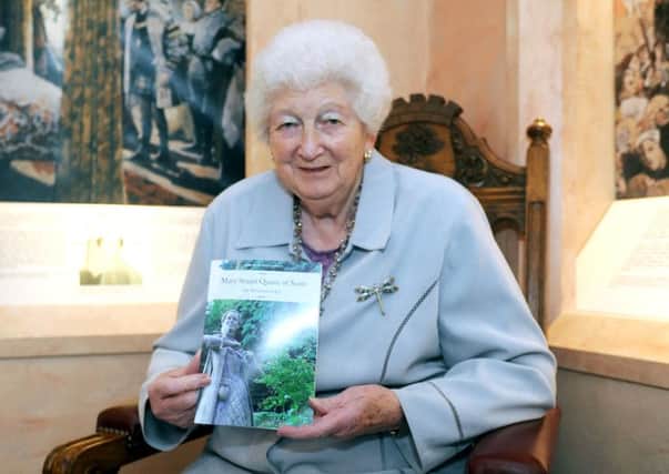 Iris McGowran MBE with one of her late husband Tom's books
Picture: John Devlin