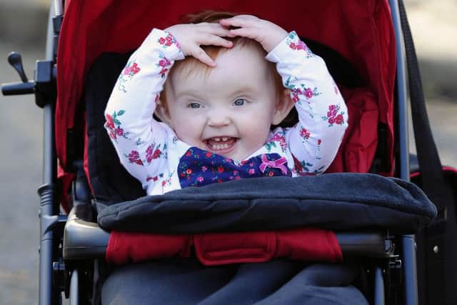 24-02-2016. Picture Michael Gillen. CARRON Vicky Laird's 14-month-old daughter Lily Linning in her new pram. Bought with money from friends at Carronbridge Inn after her pram had been stolen. Dad, Stewart Linning 33; Lily Linning and Mum, Vicky Laird 36.