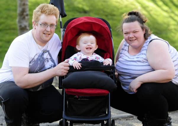24-02-2016. Picture Michael Gillen. CARRON Vicky Laird's 14-month-old daughter Lily Linning in her new pram. Bought with money from friends at Carronbridge Inn after her pram had been stolen. Dad, Stewart Linning 33; Lily Linning and Mum, Vicky Laird 36.