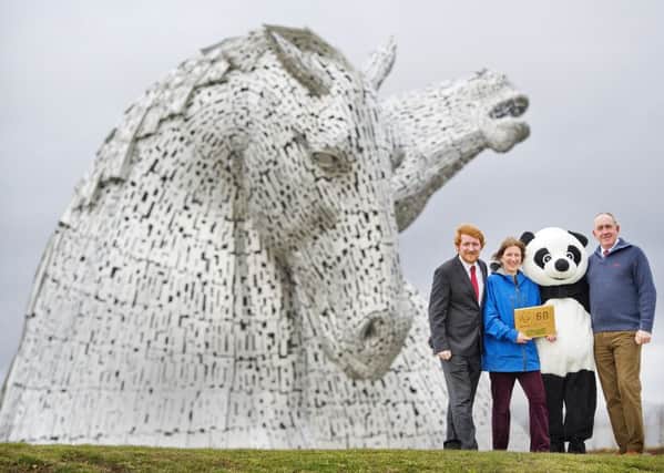 Scottish Canals receiving award from WWF Earth Hour, at The Kelpies ,  left to right, Councillor Craig Martin Olivia Lassiere,  Heritage & Environment Manager, Scottish Canals , Panda from WWF and  Ben Mardall, team leader at The Helix