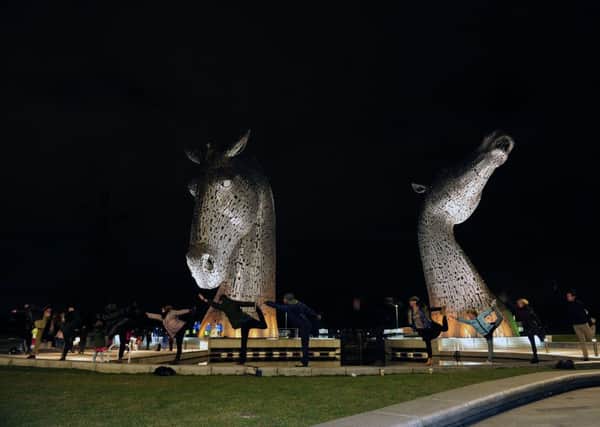 People posing in front of the unlit Kelipes during Earth Hour