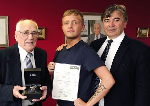 Peter Mitchell with his watch, award for length of service; Craig Maxwell with modern apprenticeship certificate and James Allan. Picture: Michael Gillen