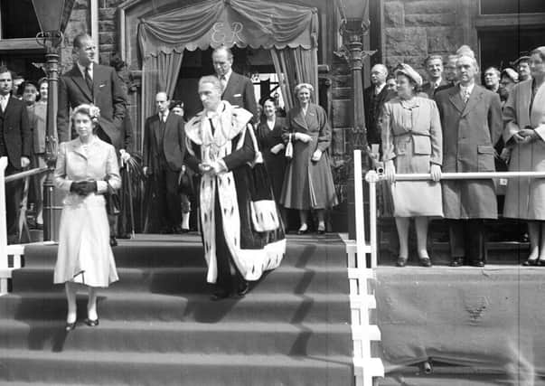 The Queen and Duke of Edinburgh leaving the Burgh Buildings in Falkirk accompanied by Provost R H Watson.  Behind the Provost is James Stuart, Secretary of State for Scotland royal visit