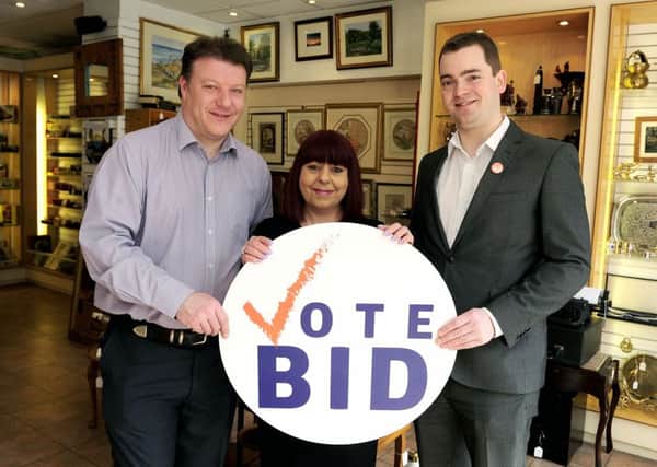 Collectique owners David and Yasmin Suckling with Edward Linton-Smith, project manager Falkirk Delivers, encouraging people to take part in the BID ballot. Picture: Michael Gillen