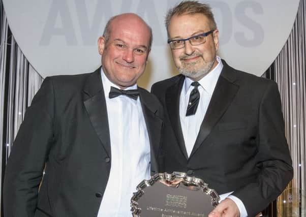 Bruce Waddell, right, receives his Lifetime Achievement Award from Austin Lafferty at the 37th Scottish Press Awards