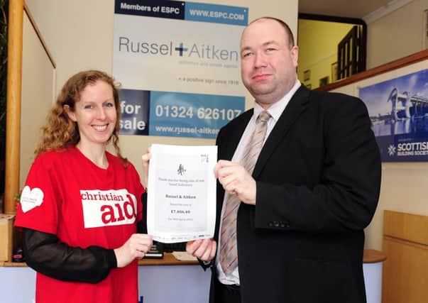 Jo Dallas, legacy coordinator Christian Aid presents Will Aid certificate for raising Â£7000 to James Brogan of Russel + Aitken
Picture: Michael Gillen