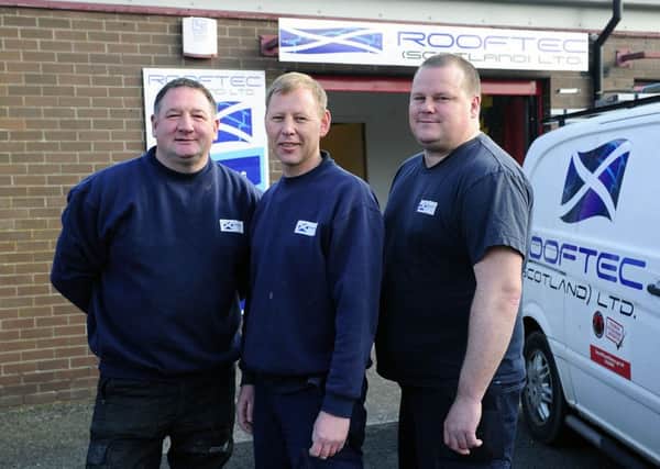 Rooftec director Mark Cattanach and his workers gave up their own time to help the pensioner. Mark, centre, with supervisors David Inglis, left, and Alister Tetsill. Picture: Michael Gillen