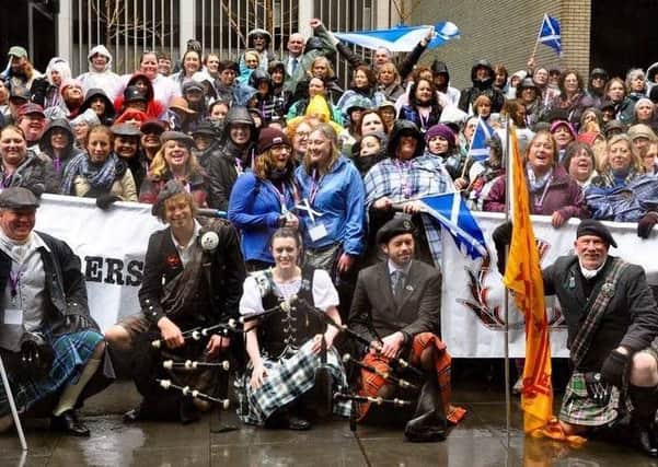 Dancer Kayleigh Boardman, front, with pipers and Outlander fans at the annual Tartan Parade in New York City.