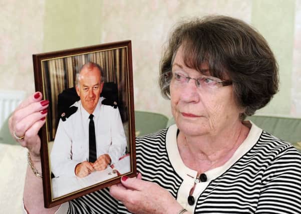 Catherine Howie with a picture of her late brother Ian Fairley, the police officer who caught Ian Brady. Picture: Michael Gillen