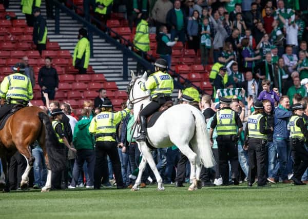 Mounted police were brought in to restore order after the pitch invasion. Picture: Robert Perry