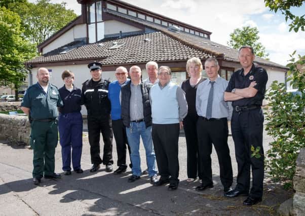 Airth residents pictured with members of the emergency services, Falkirk Council's emegency planning team and MP John McNally