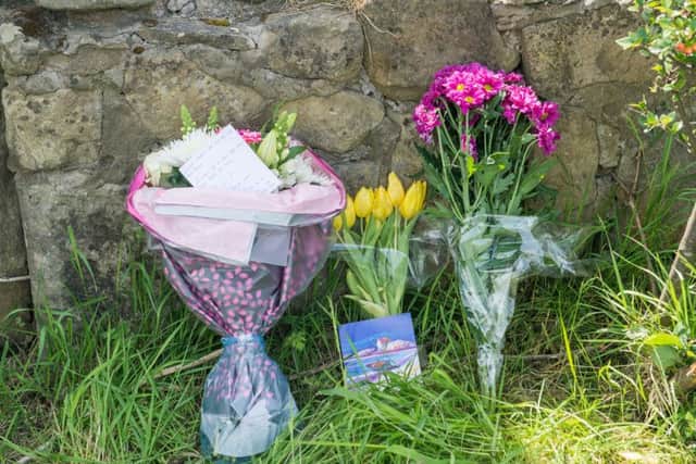 Floral tributes have been left at the scene of the accident in memory of Iain