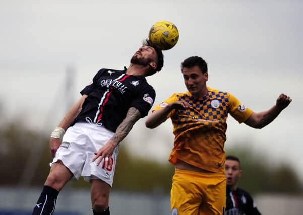 Lee Miller beats Luca Gasparotto in the air, in a combination that could be replicated at Falkirk training next season. Picture Michael Gillen