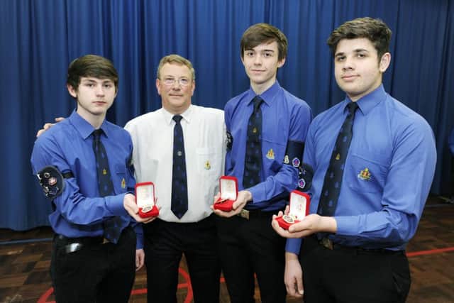 Captain Brian Allan with 2nd Larbert Queen's Badge recipients Ewan McDonald, Ross Wilson and Gregor Stirling.