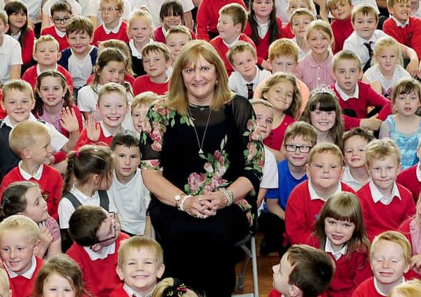 Head teacher Jill Stocks surrounded by Bonnybridge primary pupils oon her retirement day. Picture: Michael Gillen