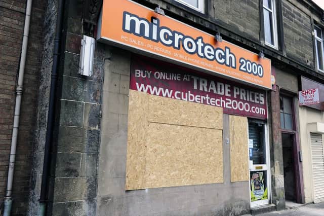 The Camelon shop remains boarded up after Wednesday's incident
Picture: Michael Gillen