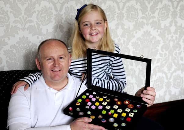 Rowan Brockie with dad Colin and the jewellery she is making and selling to raise funds for hospital where he was treated for burns
Picture: Michael Gillen