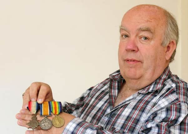 John Aitken displays the medals of his great uncle WJ Aitken  medals he will give to the family he never knew he had. Picture: Michael Gillen