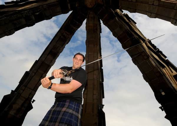 Highland Games champ Kyle Randalls with Wallaces legendary sword. Picture: Jim Mailer
