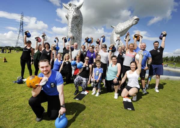 PC Niall MacKinnon and the kettlebell team at the Kelpies. Picture: Alan Murray