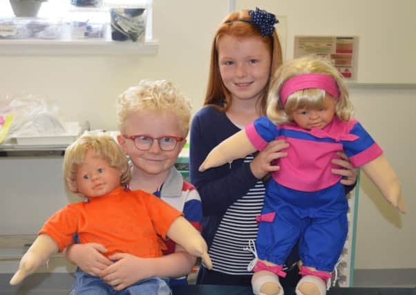 Liam Kilgour (Bridge of Allan) and Ellie Griffin (Falkirk) with the dolls that help children who are scared of needles