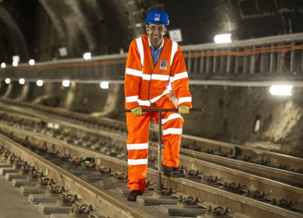 Transport Minister Humza Yousaf symbolically tightens the last bolt of the track.
