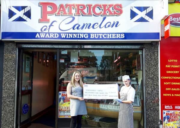 Claire McDonald of Strathcarron Hospice receives a cheque for Â£1500 from Kim of Patricks of Camelon