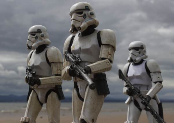 Its hard to believe these menacing Stormtroopers marching along the sand are just toys on a Scottish beach