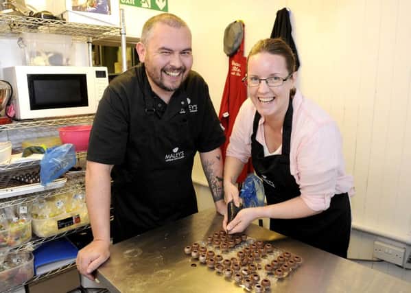 Michael  helping Louisa create her chocolate which she has named a Falkirk Fancy. Picture: Michael Gillen